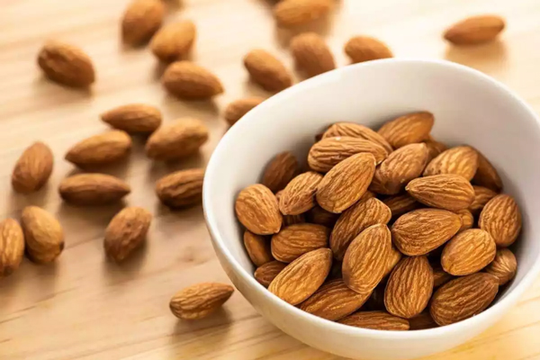 Imagen de un recipiente con almendras, las cuales poseen muchas vitaminas que son efectivas para reducir la caída del cabello