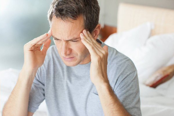 Hombre con canas se levanta de la cama con un persistente dolor de cabeza horas después de una cirugía para recuperar la densidad de su cabello