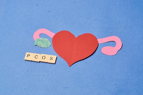 Síndrome de ovario poliquístico - Figura en papel con un corazón que representa las trompas de falopio, puesta sobre una mesa