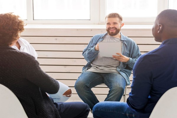 imagen de un grupo de hombres en una terapia de grupo contando sus experiencias con la alopecia