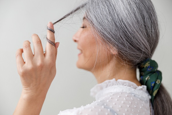 mujer con canas con una actitud alegre